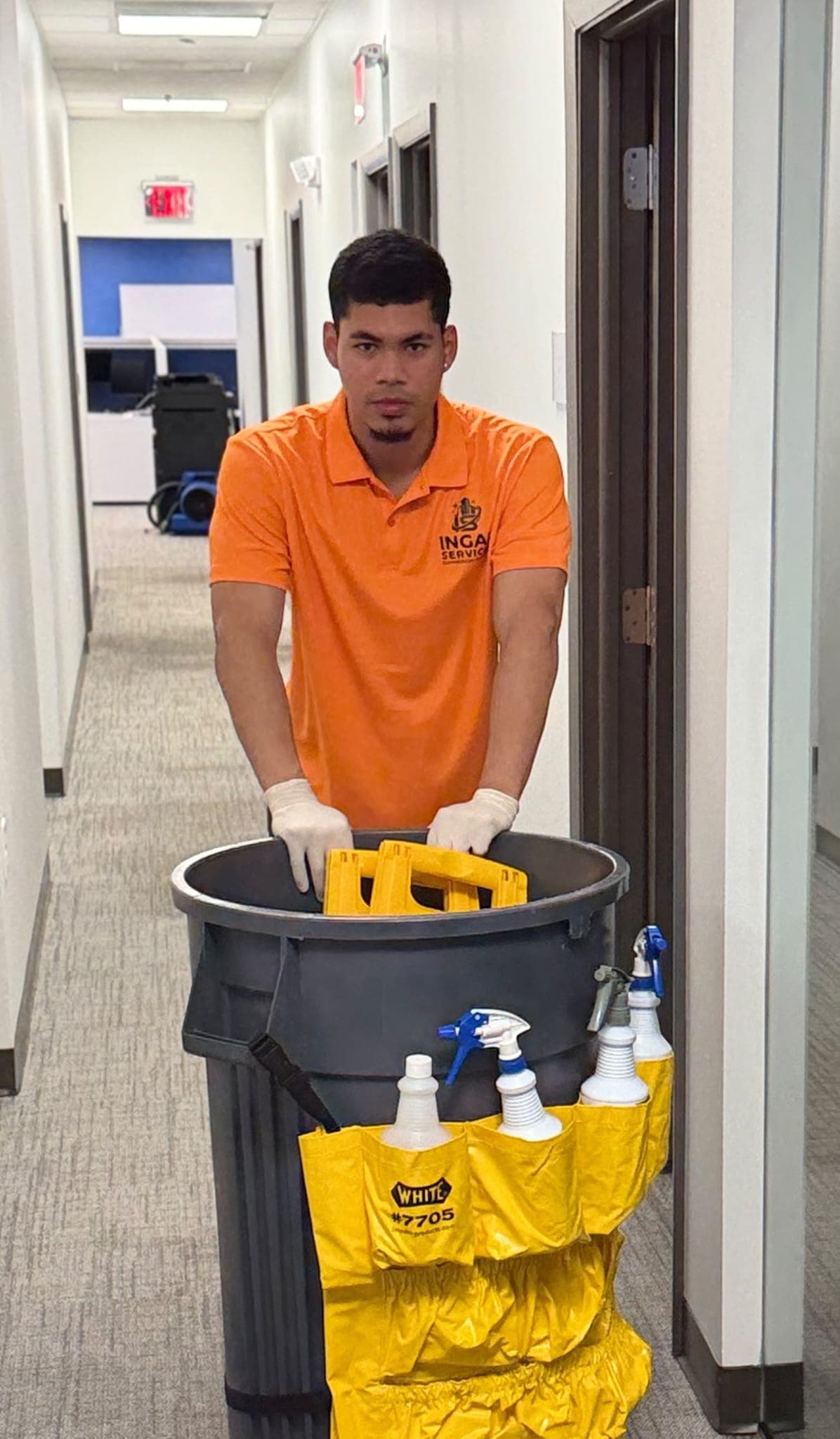 INGAL SERVICES INC employee wheeling a stocked janitorial cart between office suites