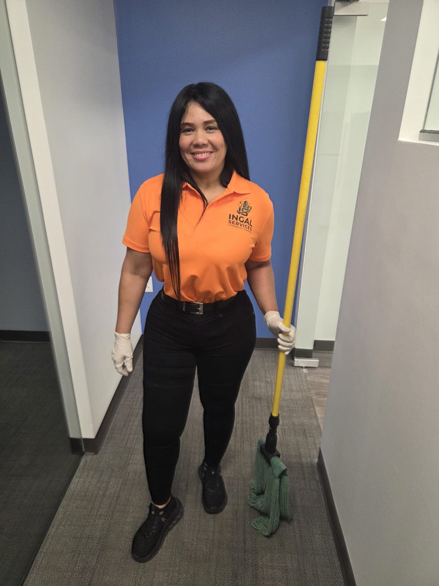 INGAL SERVICES INC crew lead holding a mop, ready to begin an evening cleaning route